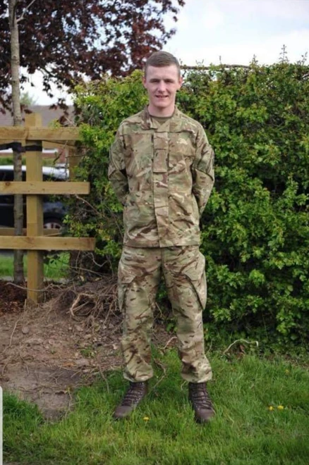 Leon standing in camo uniform Leon standing in camo uniform