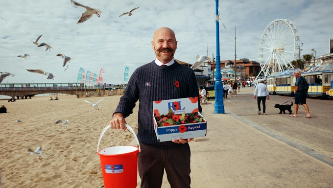 Dave Kelsey holding Poppy Appeal collection bucket