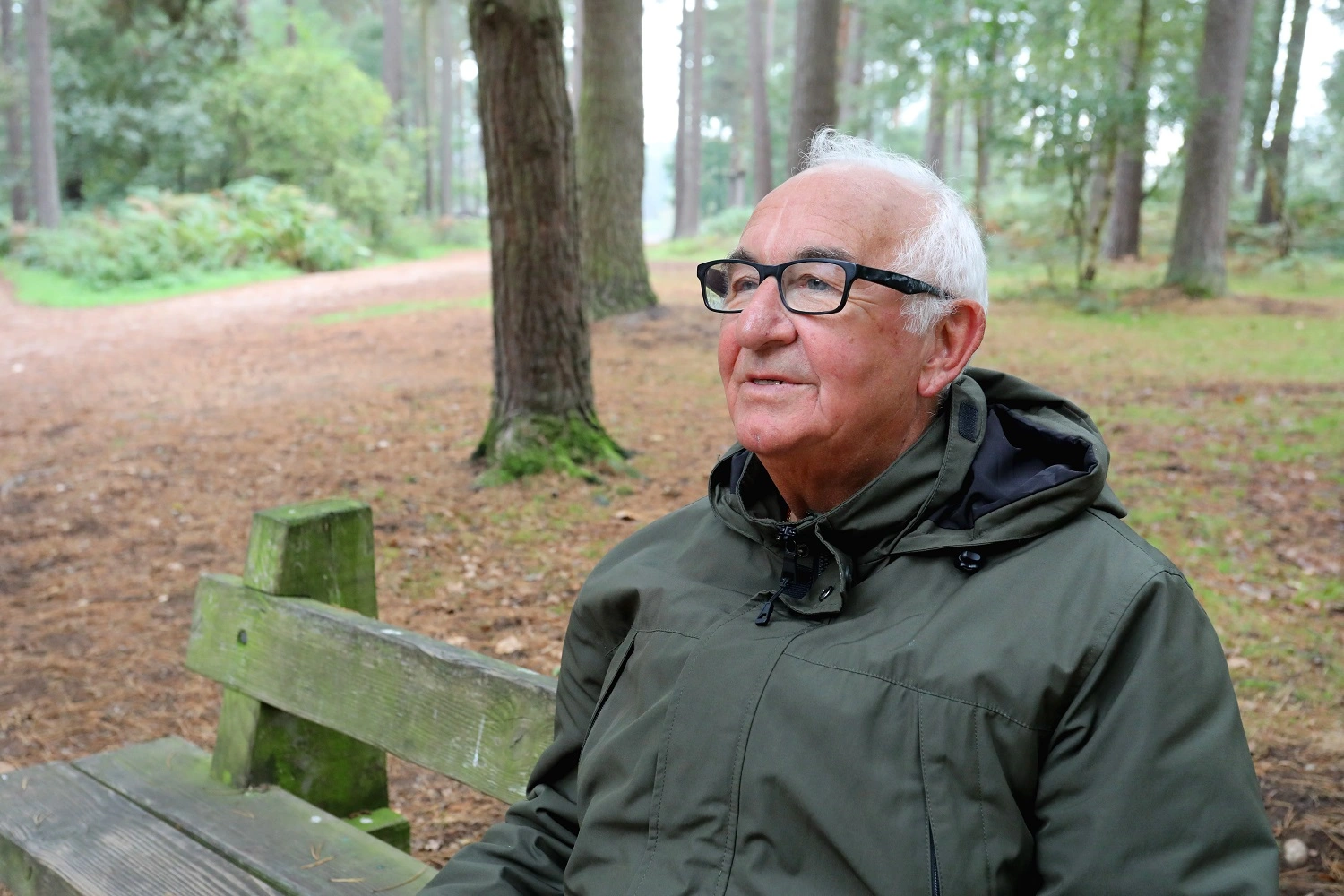 Army veteran Malcolm sat on a bench in a park
