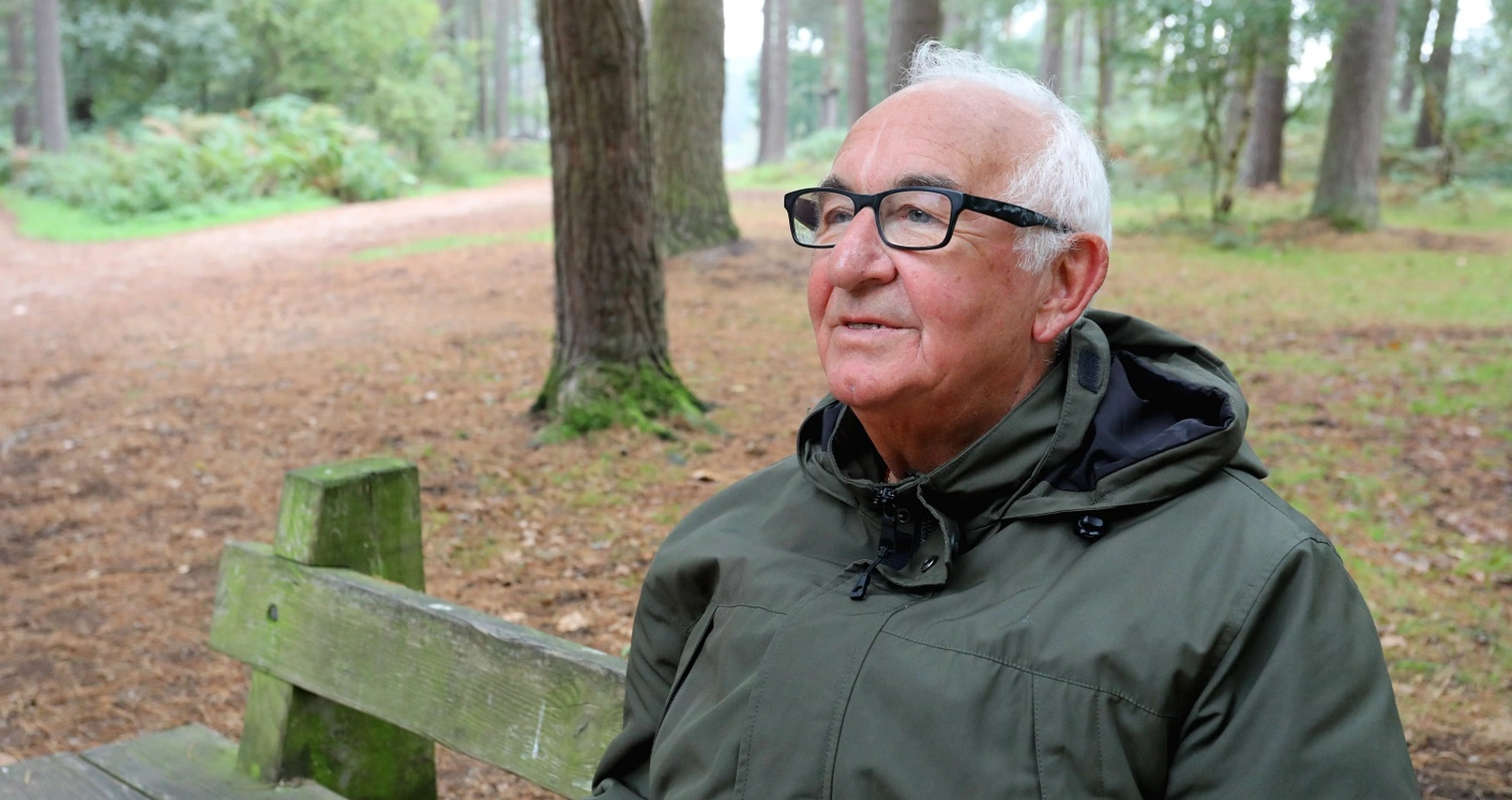 Army veteran Malcolm sat on a bench in a park