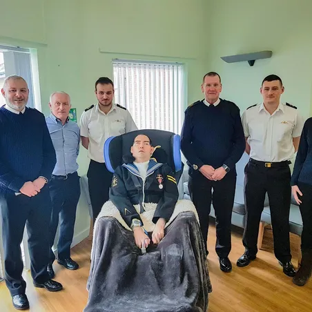 The Legion and Navy representatives present the Reynolds' with Paul's wheelchair 