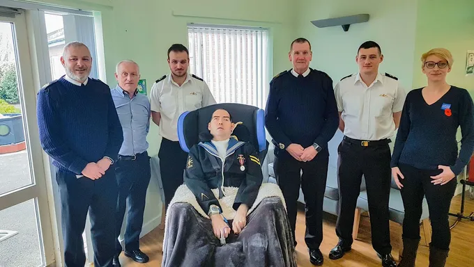 The Legion and Navy representatives present the Reynolds' with Paul's wheelchair 