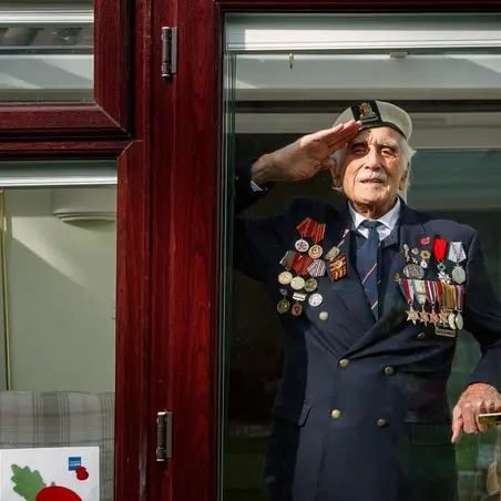 Bill_Taylor_RBL_071-Edit_HR Bill Taylor saluting behind a window