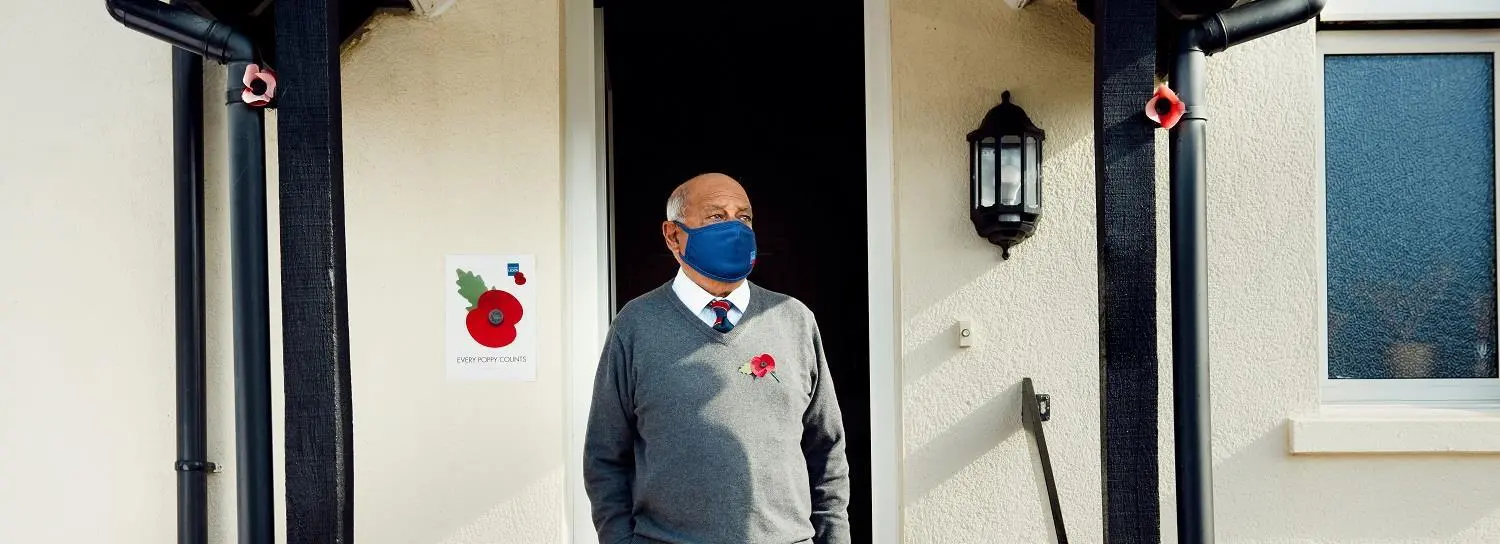 Flyle Hussain outside his house wearing a face mask