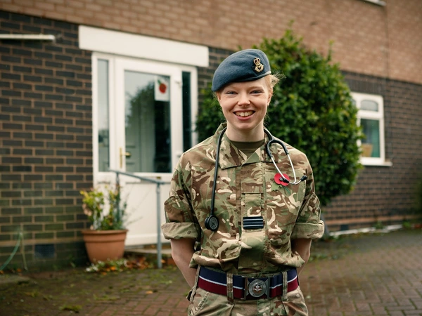 Samantha Rawlinson outside her front door in uniform with stethoscope
