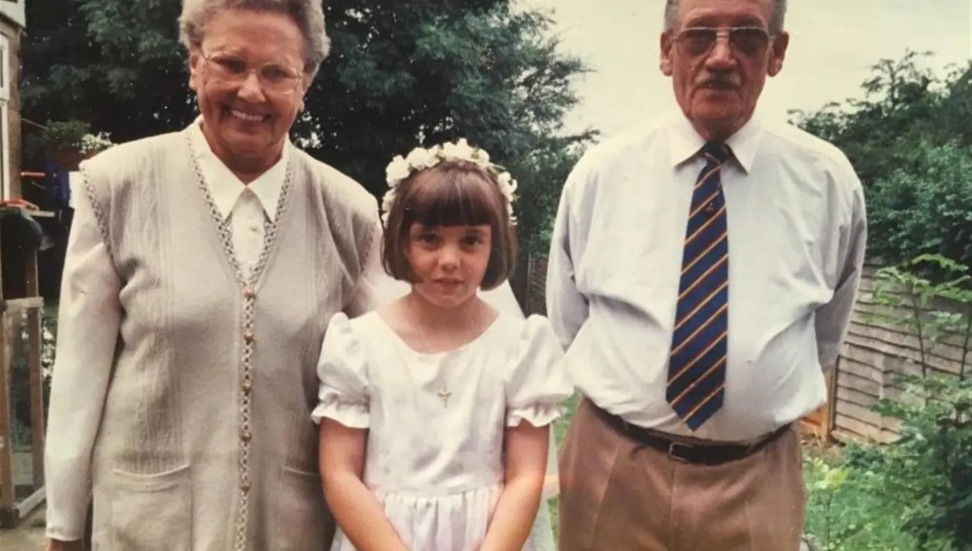 Rachel Hughes with grandparents as a young child.