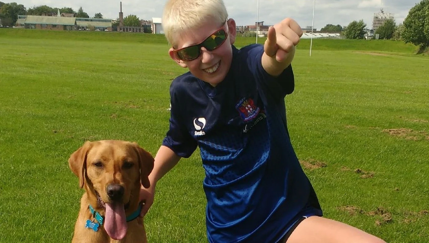 story_autism_dog_rigby_hero Jake with Autism assistance dog Rigby in the park