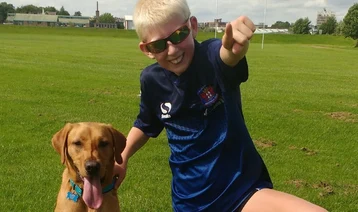 Jake with Autism assistance dog Rigby in the park