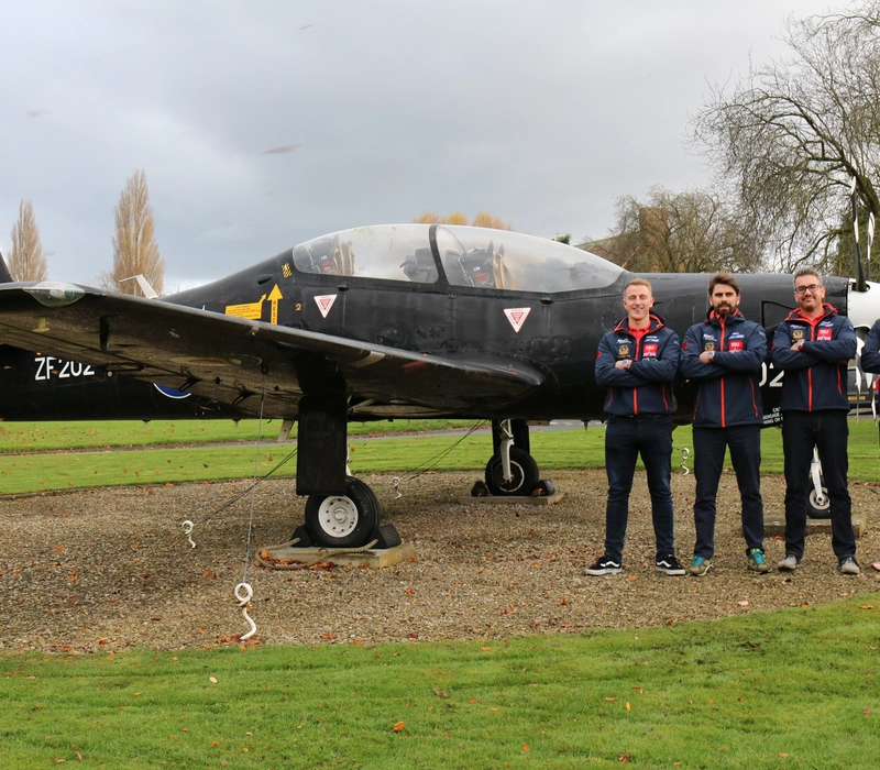 Row 4 Victory Team The team standing in front of a plane.