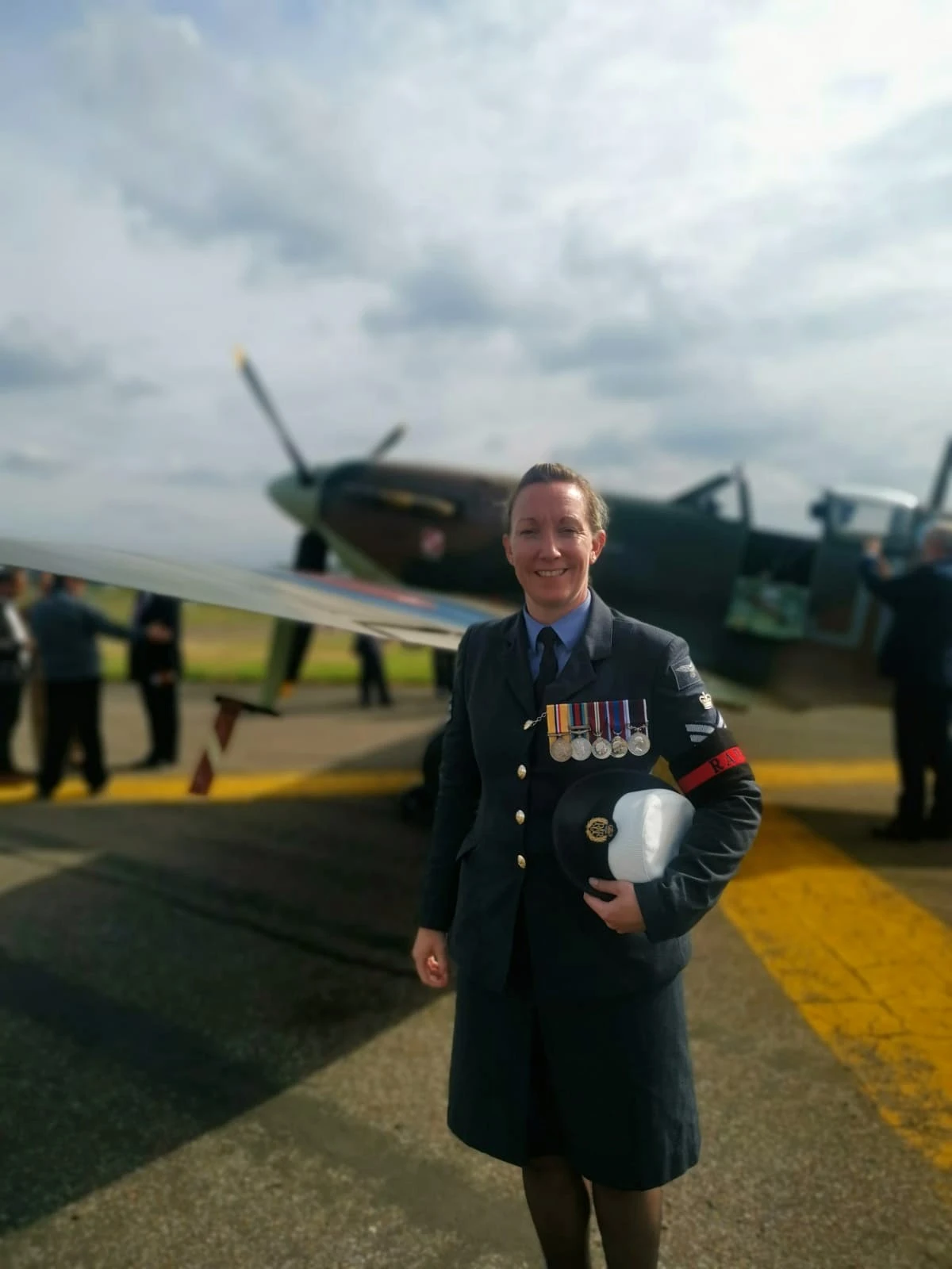 Stacey Denyer in her RAF uniform standing in front of an aircraft