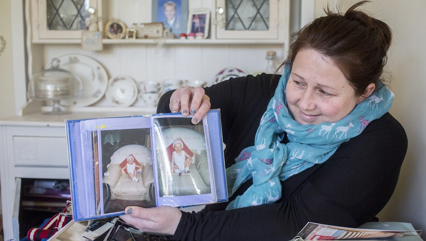 Stacey looking at pictures of her daughter