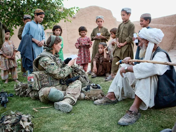 Anna Crossley in Afghanistan talking to Afghani children and elderly.