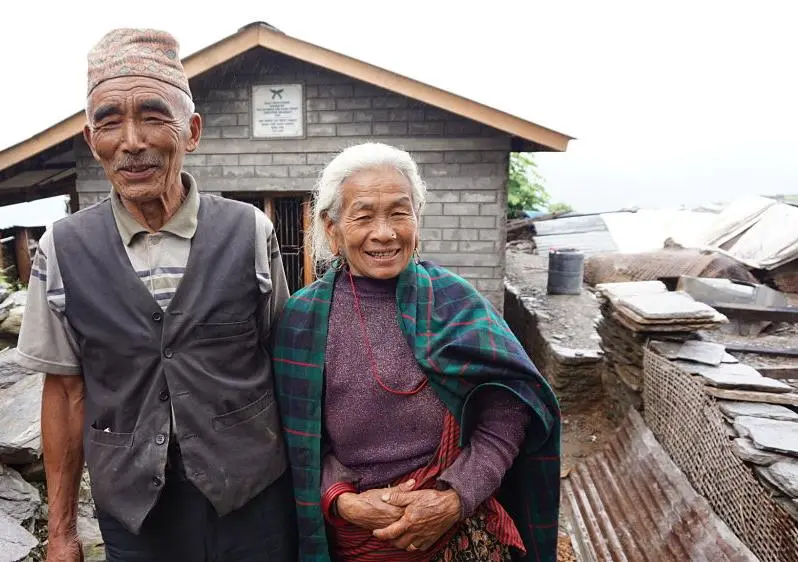  Baldhan and Budhini stood outside their newly build earthquake resistant home