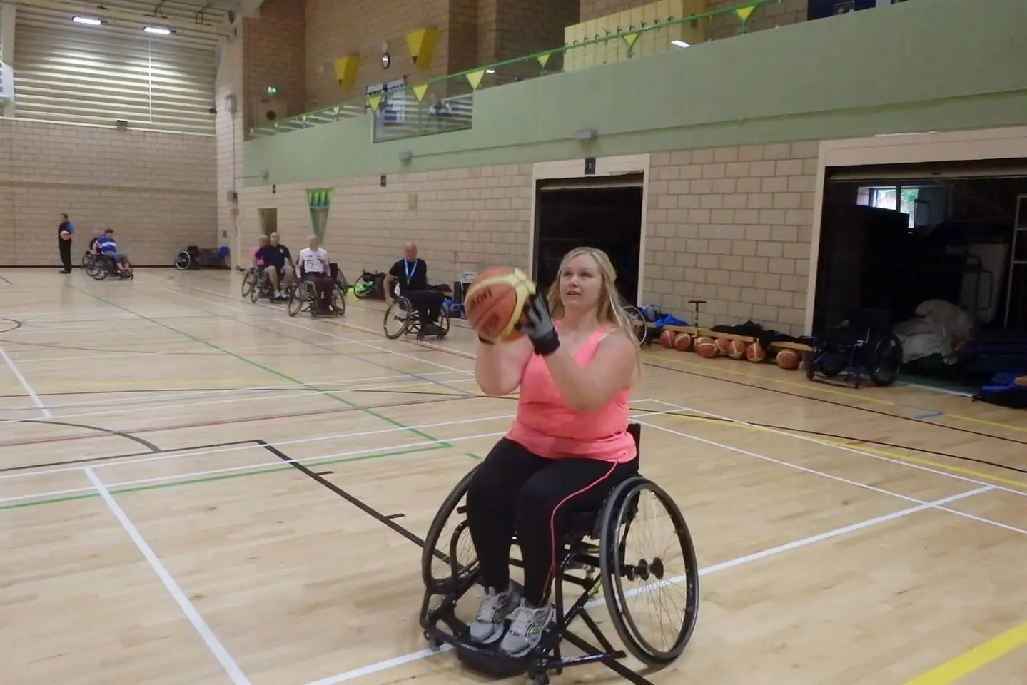 Naomi playing wheelchair basketball