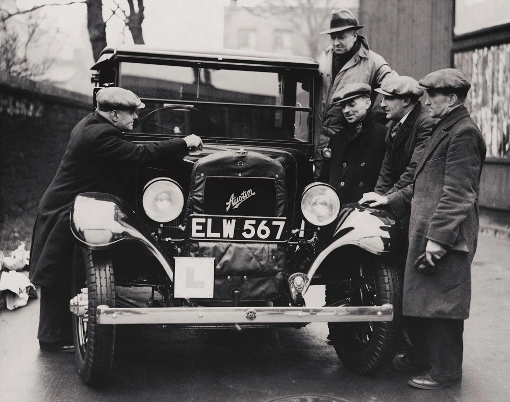 Recruits at the British Legion Taxi School examine a newly delivered taxi