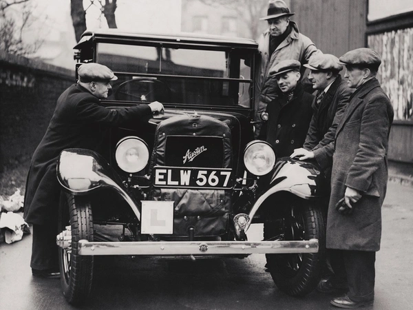 Recruits at the British Legion Taxi School examine a newly delivered taxi