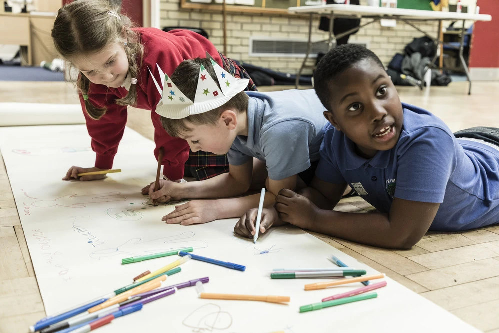 School children working on an art project together