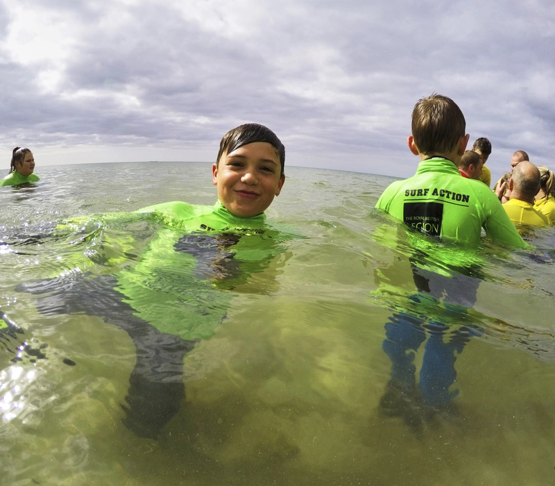 Children in the water at a Surf Action surf session
