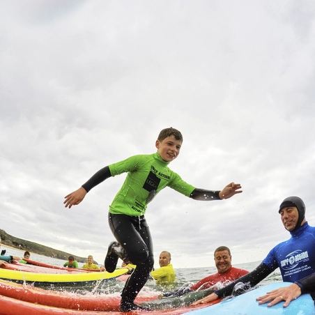 Children taking part in a surf lesson