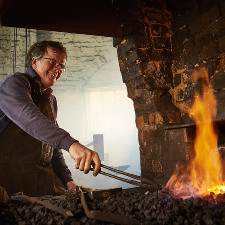 Veteran Tim Mackareth in his blacksmith workshop 