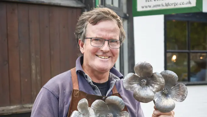 Tim Mackareth holding metal poppies