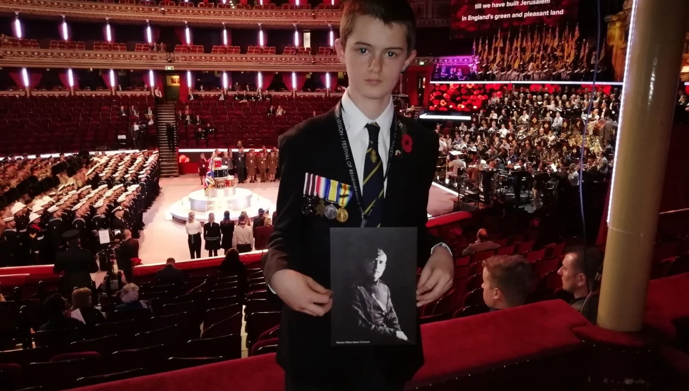 Toby Castle - Festival of Remembrance 2018 - Wearing medals and holding portrait of Martin O'Connor Toby Castle - Festival of Remembrance 2018 - Wearing medals and holding portrait of Martin O'Connor