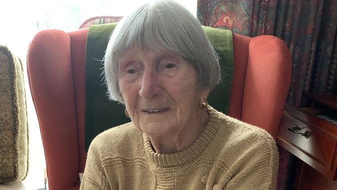 Joan Hall in armchair at home