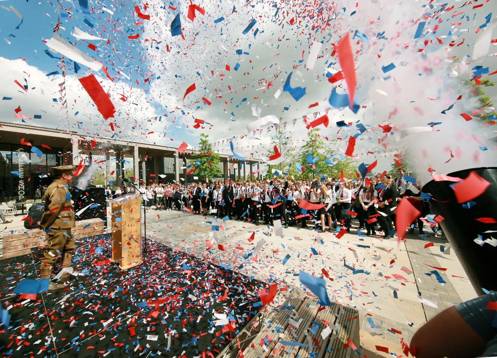 Students running towards confetti