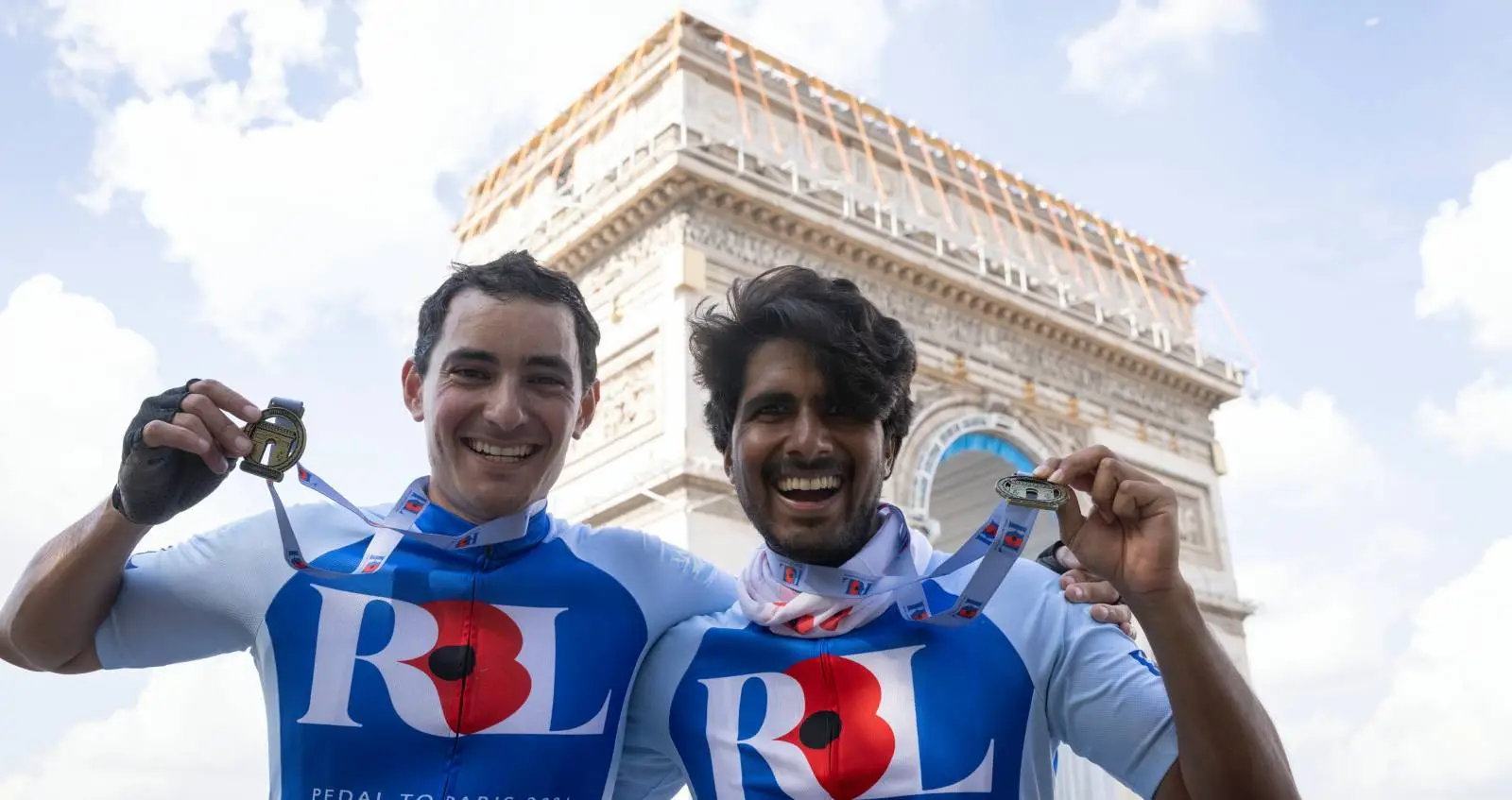 Men with medals in front of Arc de Triomphe
