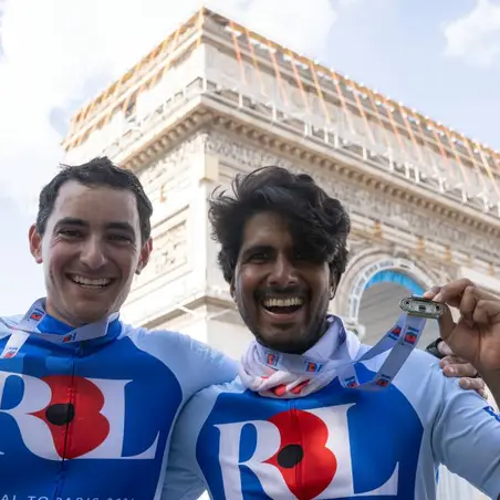 Men with medals in front of Arc de Triomphe
