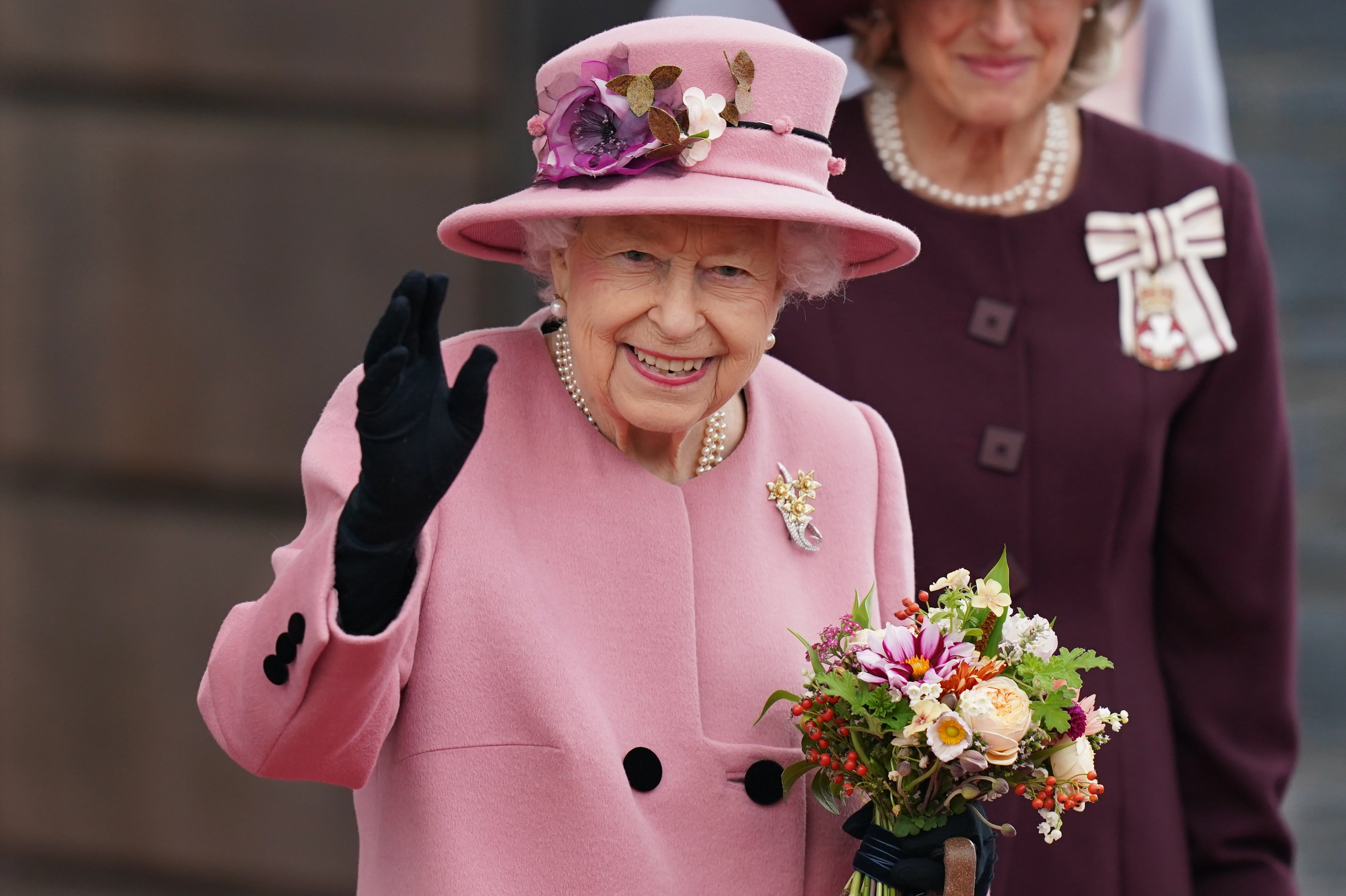 HM The Queen holding bunch of flowers