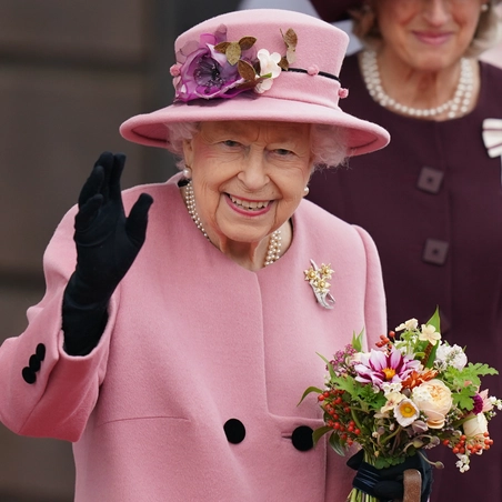HM The Queen holding bunch of flowers