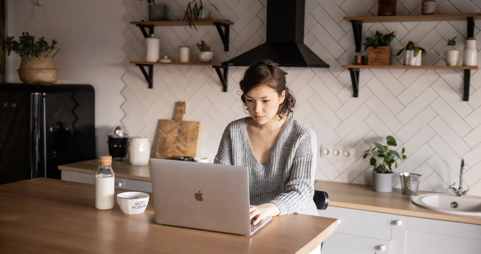 Woman on laptop in kitchen