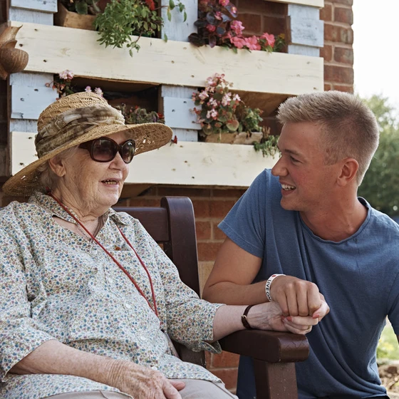 A young volunteer spending time with a care home resident