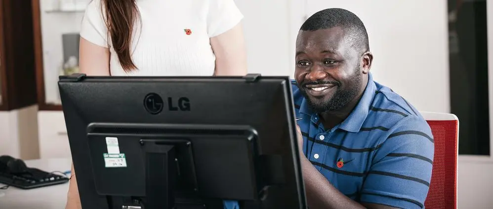 A volunteering looking at his computer screen 