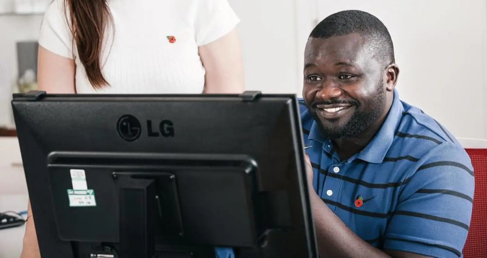A volunteering looking at his computer screen 
