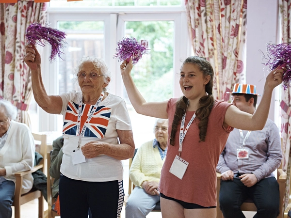 A volunteer in a care home with a member of the Armed Forces community