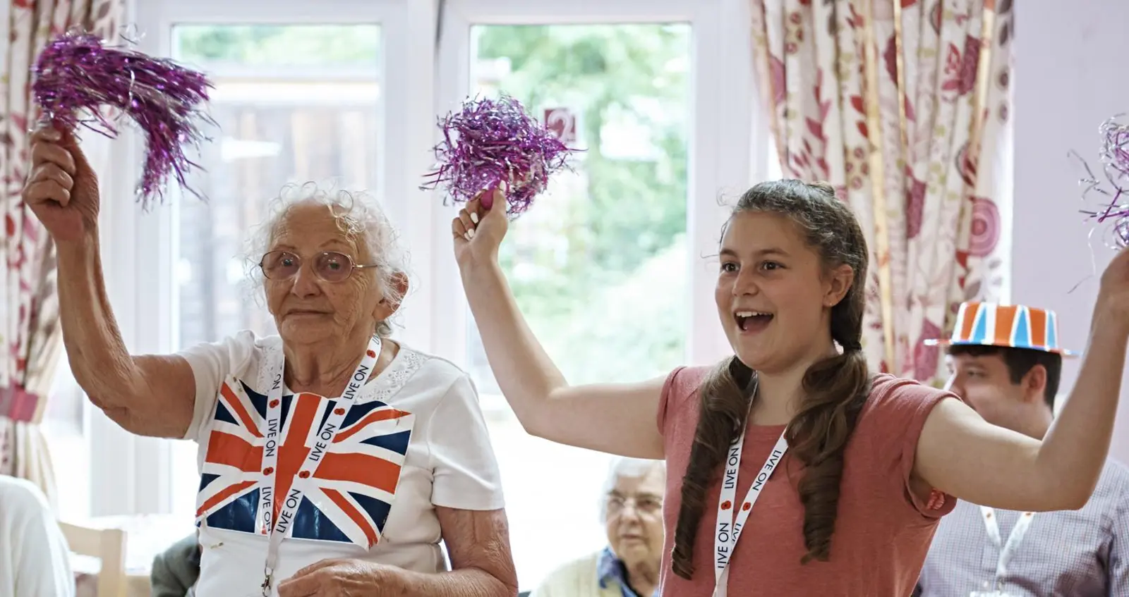 A young volunteer with a care home resident