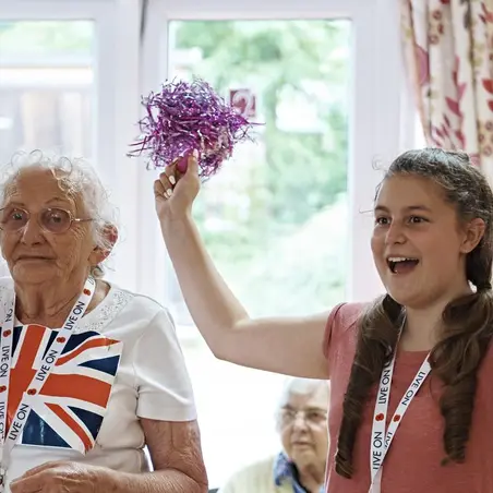 A young volunteer with a care home resident