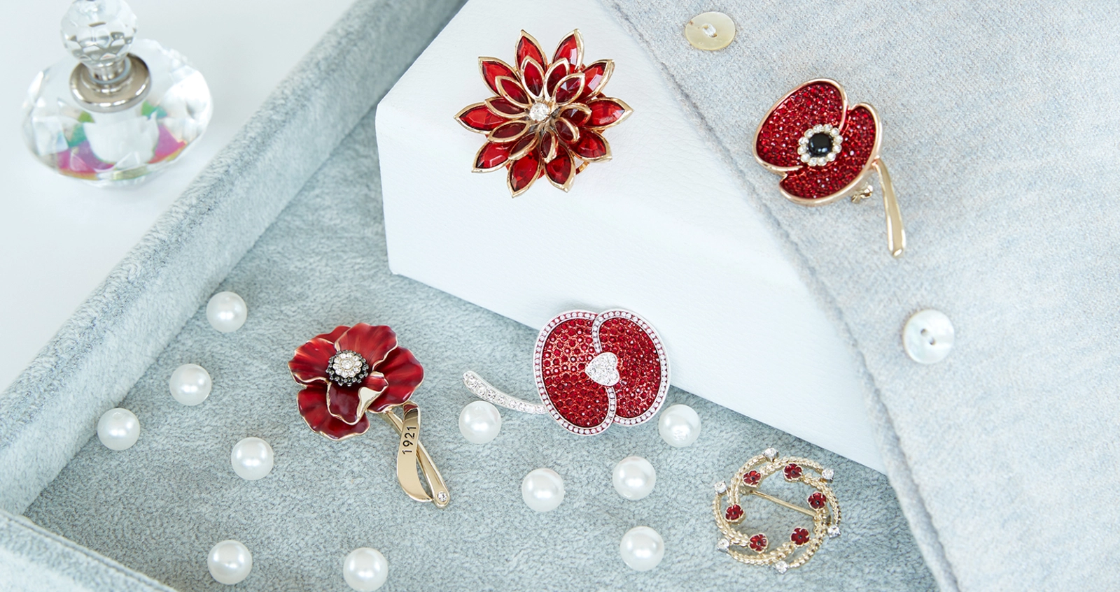 Poppy brooches and pins on a table