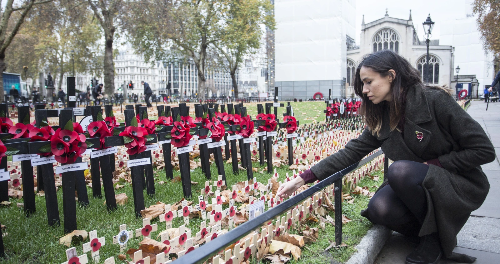 Woman planting tribute in the Westminster Fields of Remembrance